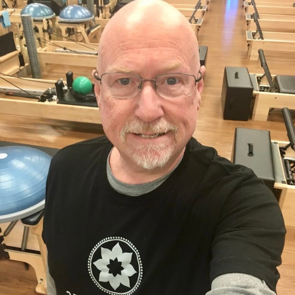 Middle aged male Pilates instructor in Club Pilates studio