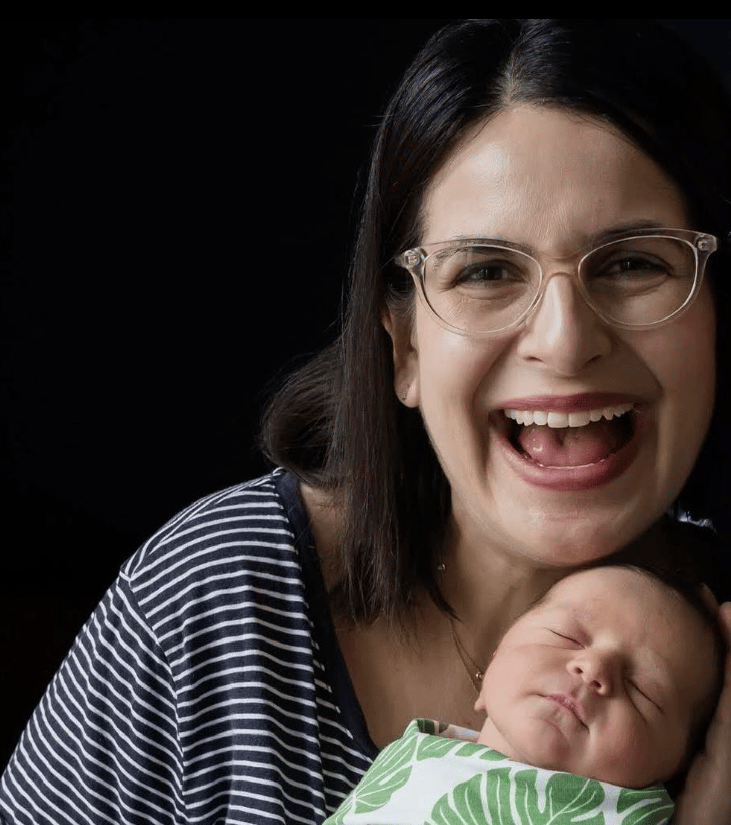 Smiling woman and newborn baby